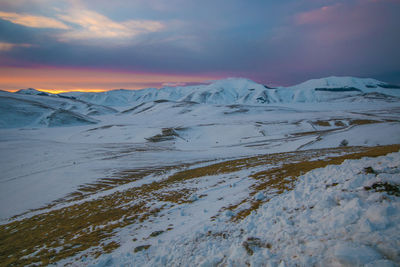 Enchanted view of pian grand at dusk with snow in umbria