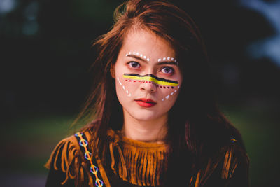 Portrait of beautiful young woman with painted face