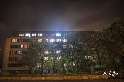 Illuminated city against sky at night