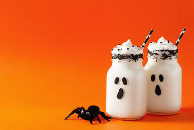 Close-up of stuffed toy against orange background