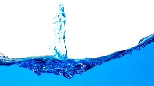 Close-up of water splashing against white background