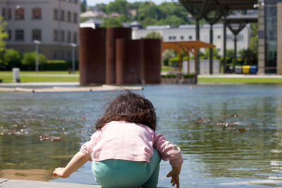 Rear view of boy looking at lake