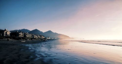 Scenic view of beach against sky during sunset