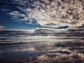 Scenic view of sea against cloudy sky