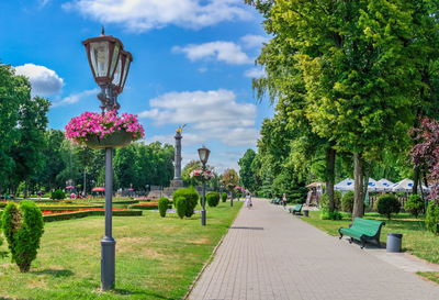 Footpath in park against sky