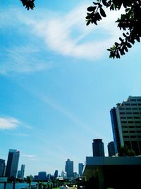 Low angle view of buildings against cloudy sky