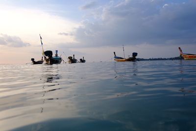 People on sea against sky