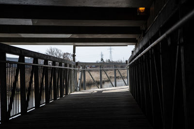 Empty footbridge against sky