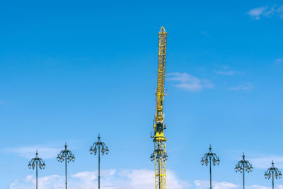 Low angle view of communications tower against blue sky