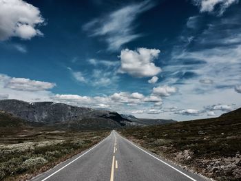 Road amidst landscape against sky