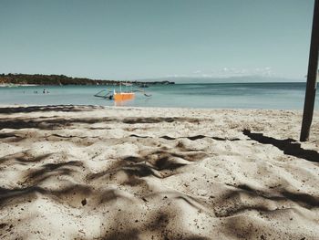 Scenic view of beach against clear sky