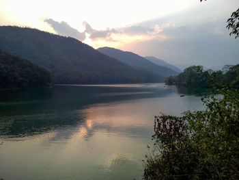 Scenic view of lake against sky at sunset