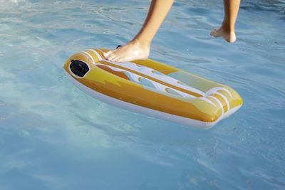 Low section of child in swimming pool