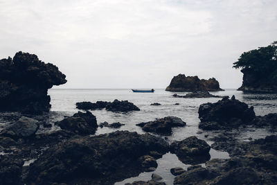 Scenic view of sea against cloudy sky