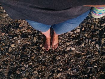 Low section of woman standing on rocks