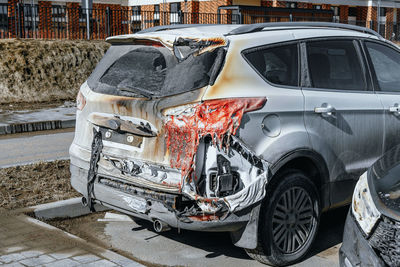Car damaged by fire. plastic auto parts melted, car's paint has deteriorated. arson of a vehicle.
