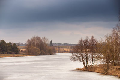 Frozen river against sky