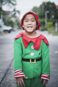 Portrait of smiling boy in costume standing outdoors