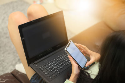 Midsection of woman using mobile phone