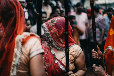 People holding umbrella on street