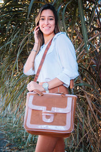 Portrait of gorgeous teen girl wearing leather bag