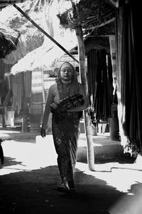 Woman in traditional clothing while walking in village