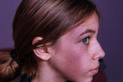 Close-up of girl looking away at home