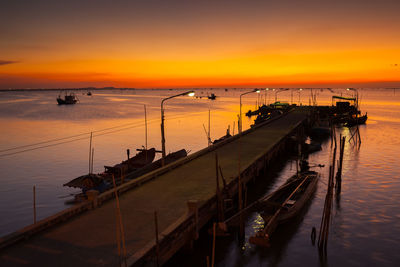 High angle view of pier on sea against sky during sunset