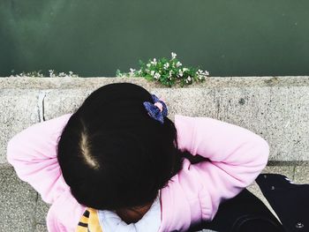 Girl standing on bridge by river