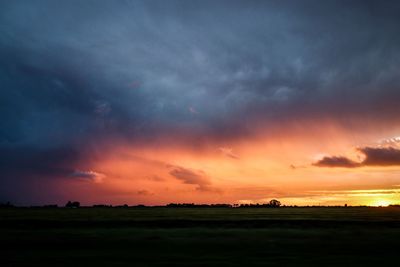 Scenic view of dramatic sky over landscape