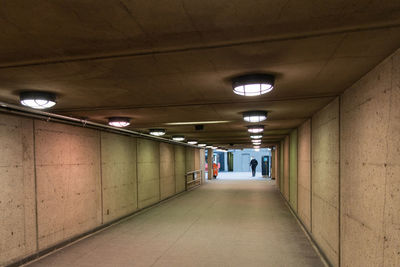 Empty corridor in illuminated building