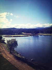 Scenic view of lake against cloudy sky