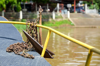 Close-up of rope on railing against river