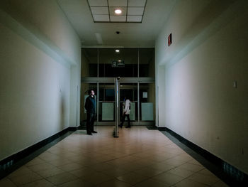 People standing in illuminated building