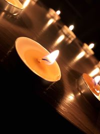 High angle view of lit tea light candles