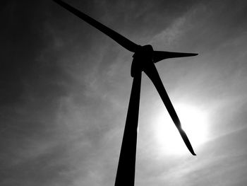 Low angle view of silhouette windmill against sky