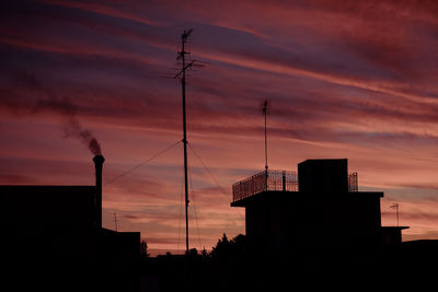 Low angle view of silhouette buildings against sky during sunset