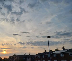 Low angle view of buildings against sky during sunset