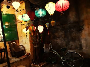 Illuminated lanterns hanging on wall at home