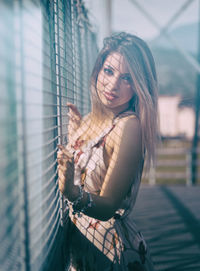 Portrait of young woman standing outdoors