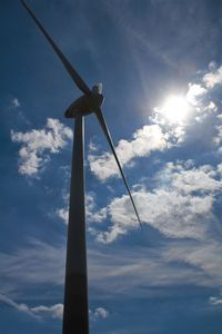 Low angle view of windmill against sky