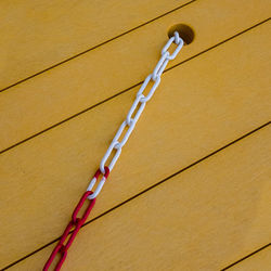 Close-up of rope tied on wooden floor