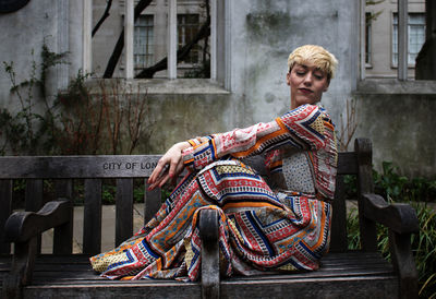 Full length of woman sitting on bench