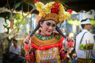 Portrait of woman wearing traditional clothing with make-up and flowers