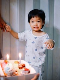 Portrait of cute girl blowing birthday cake