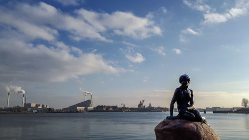 Statue of woman with river in background