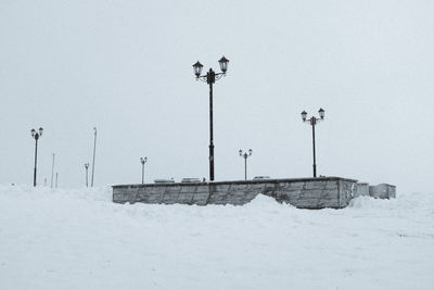 Street light on snow against sky