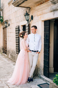 Couple standing in front of building