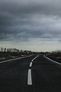 Empty road along trees