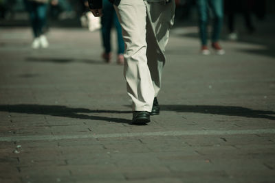 Low section of people walking on street